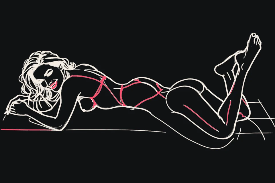 A woman lies on her stomach with her bare feet raised