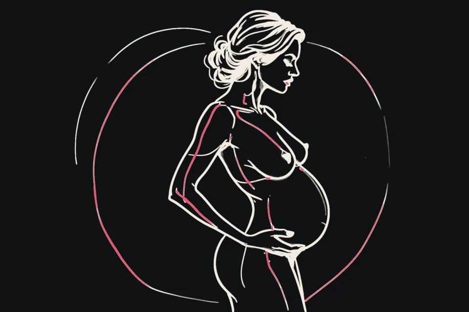 A pregnant woman in profile cradles her belly